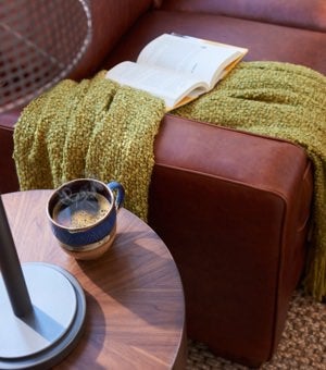 Closeup of Meyer Sofa arm and table with book and coffee